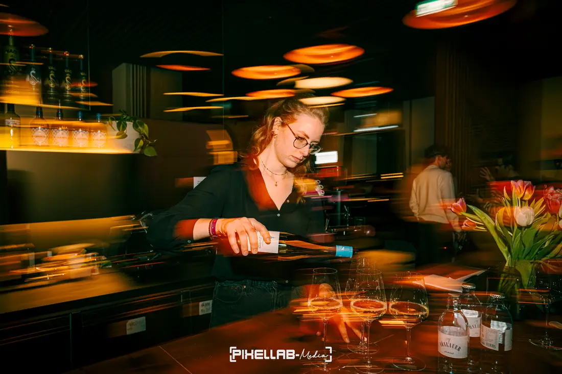 Bartender pouring a drink, motion blur in the bar