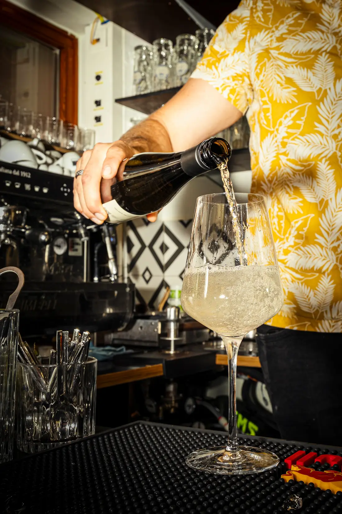 Sparkling wine being poured into a glass at the bar