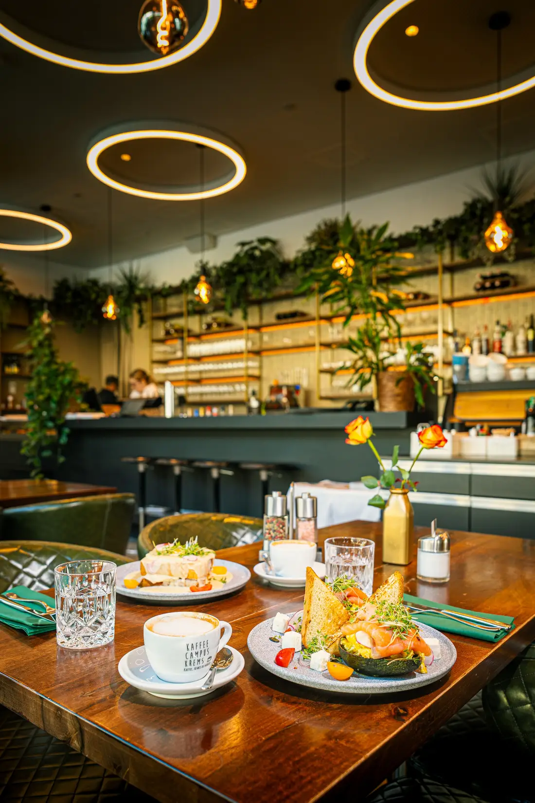 Table set with breakfast dishes in a restaurant with ring lights
