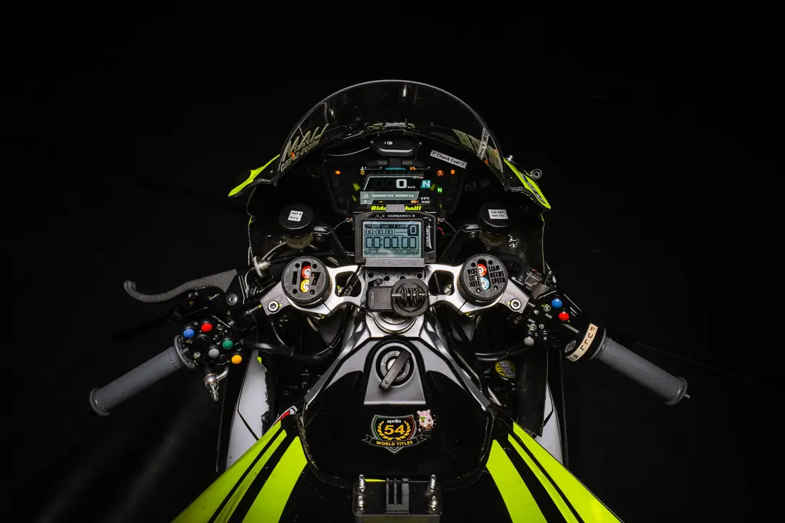 Cockpit of a racing motorbike from above with display and colourful handlebar switches